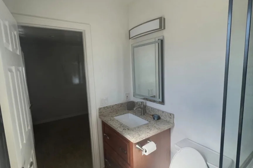 Bathroom repainted in a warm white around the vanity and shower, a Tony's Painting interior job in San Diego County