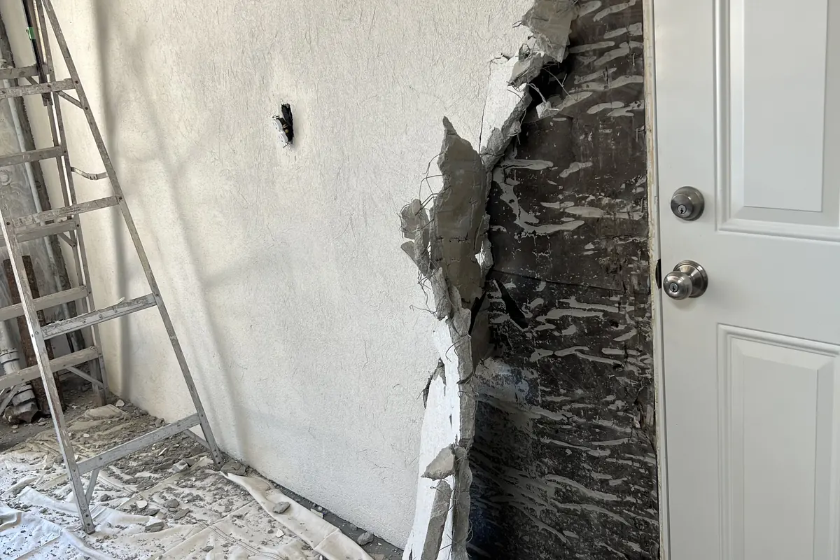 Water damage opened up beside the garage door, a Tony's Painting job in San Diego County
