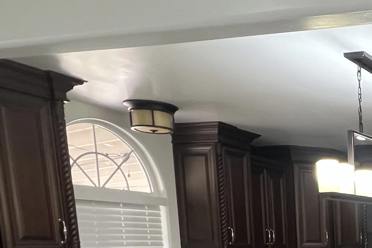 Kitchen walls and ceiling freshly painted around dark cabinets, a Tony's Painting interior job in San Diego County